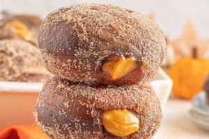 Photo of Pumpkin Cream Filled Donuts with text overlay for Pinterest.