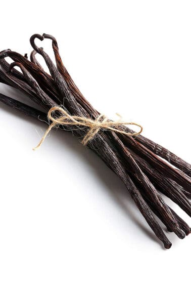 Group of vanilla beans tied with brown twine.