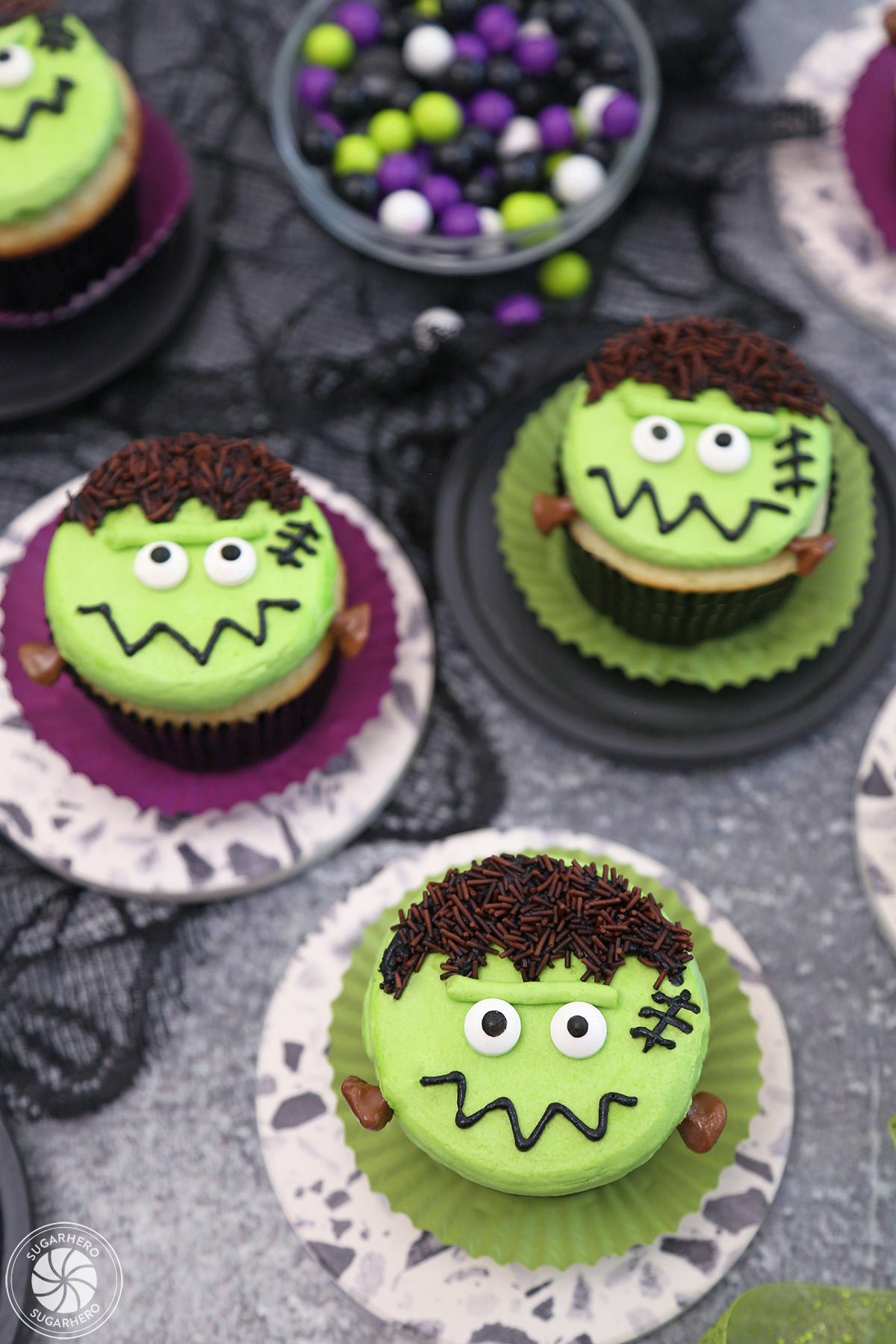 3 Frankenstein Cupcakes on colorful wrappers.