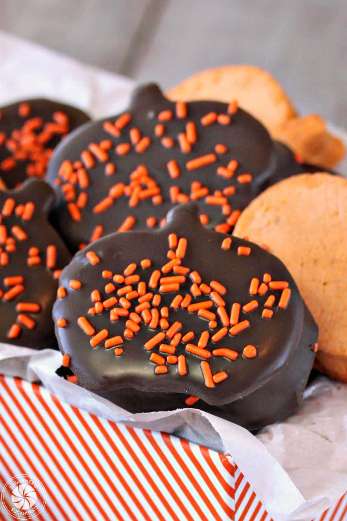 Assortment of Pumpkin Marshmallows, some dipped in chocolate, in an orange-striped gift box.