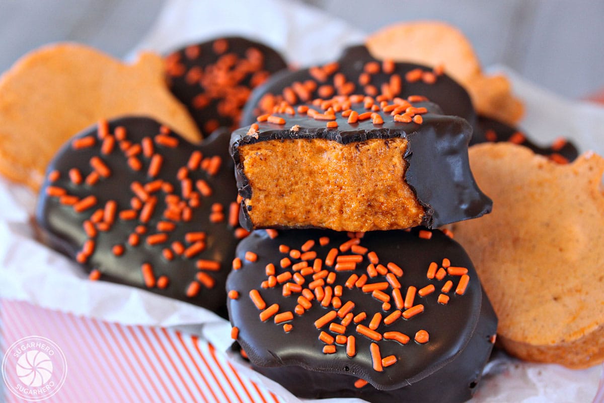 Close up of a chocolate-dipped Pumpkin Marshmallow with a bite taken out of it.