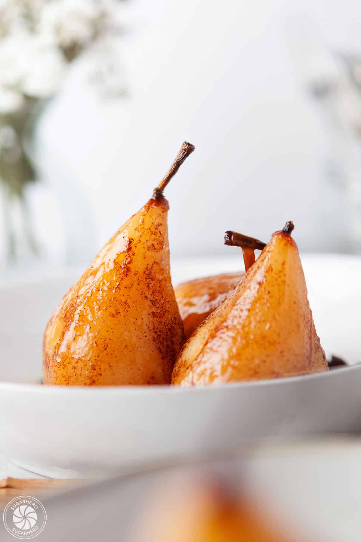 3 Poached Pears in a white bowl.