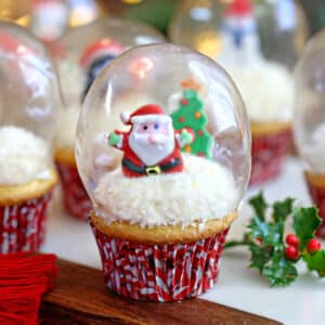 Cupcake decorated to look like a snow globe, with candy Santa inside.