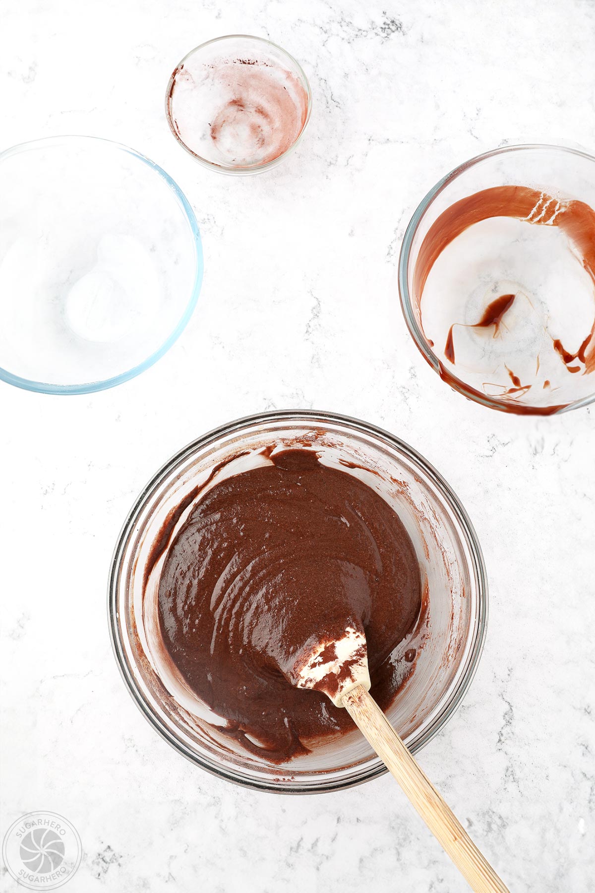 Brownie batter mixed in a large glass bowl.