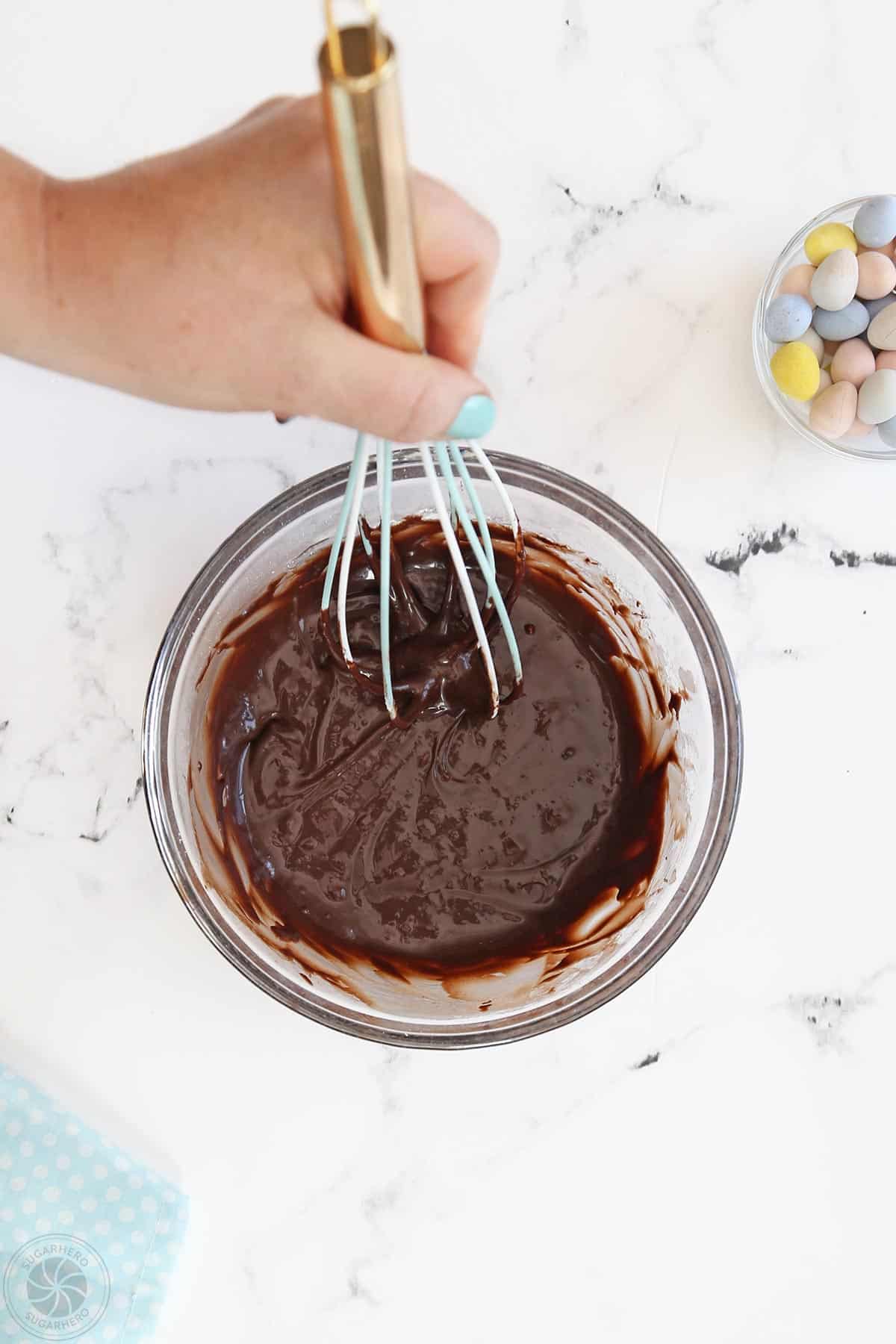 Whisking together all ingredients to make chocolate frosting.