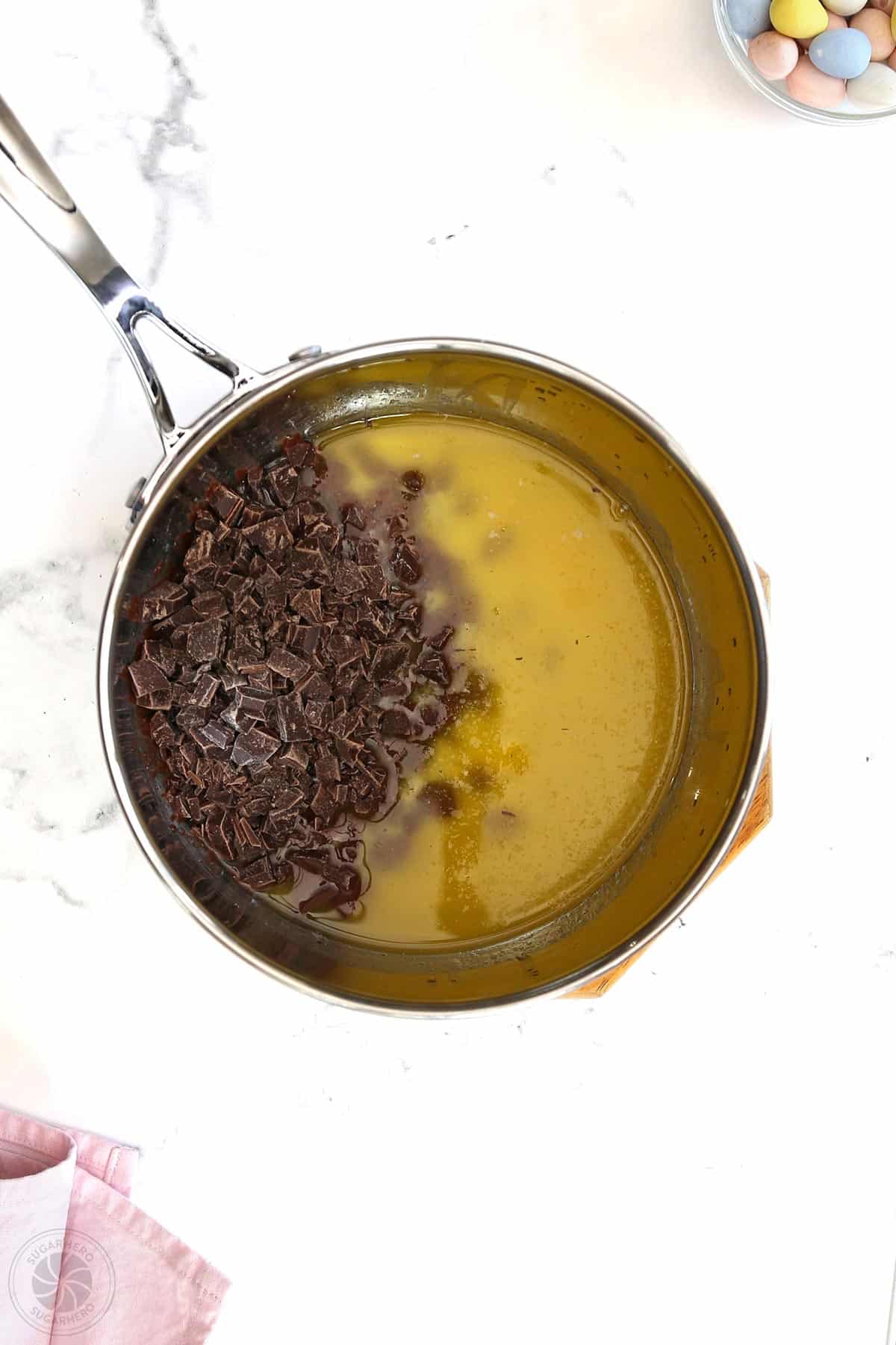Combining melted butter and chopped chocolate.
