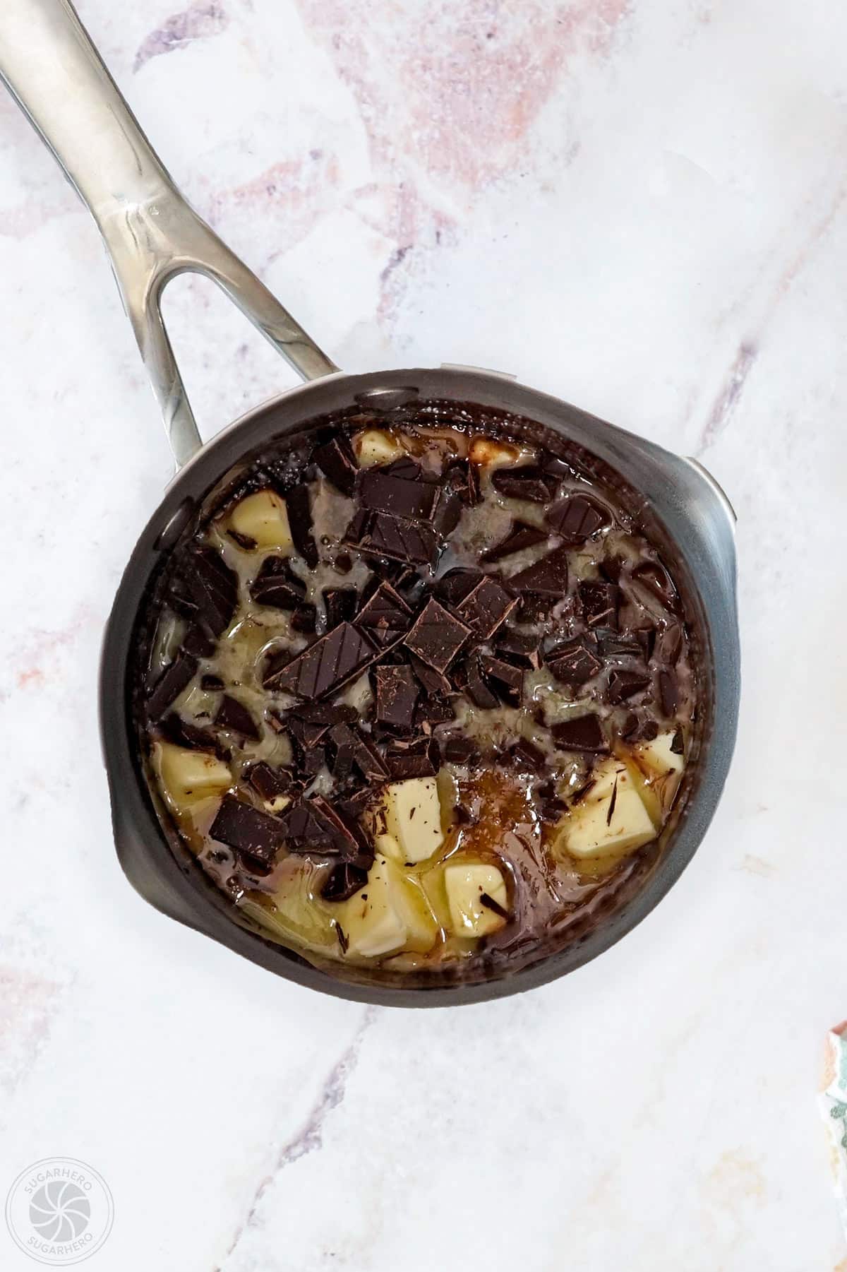 Chocolate and butter added to the simmering chocolate spread mixture.