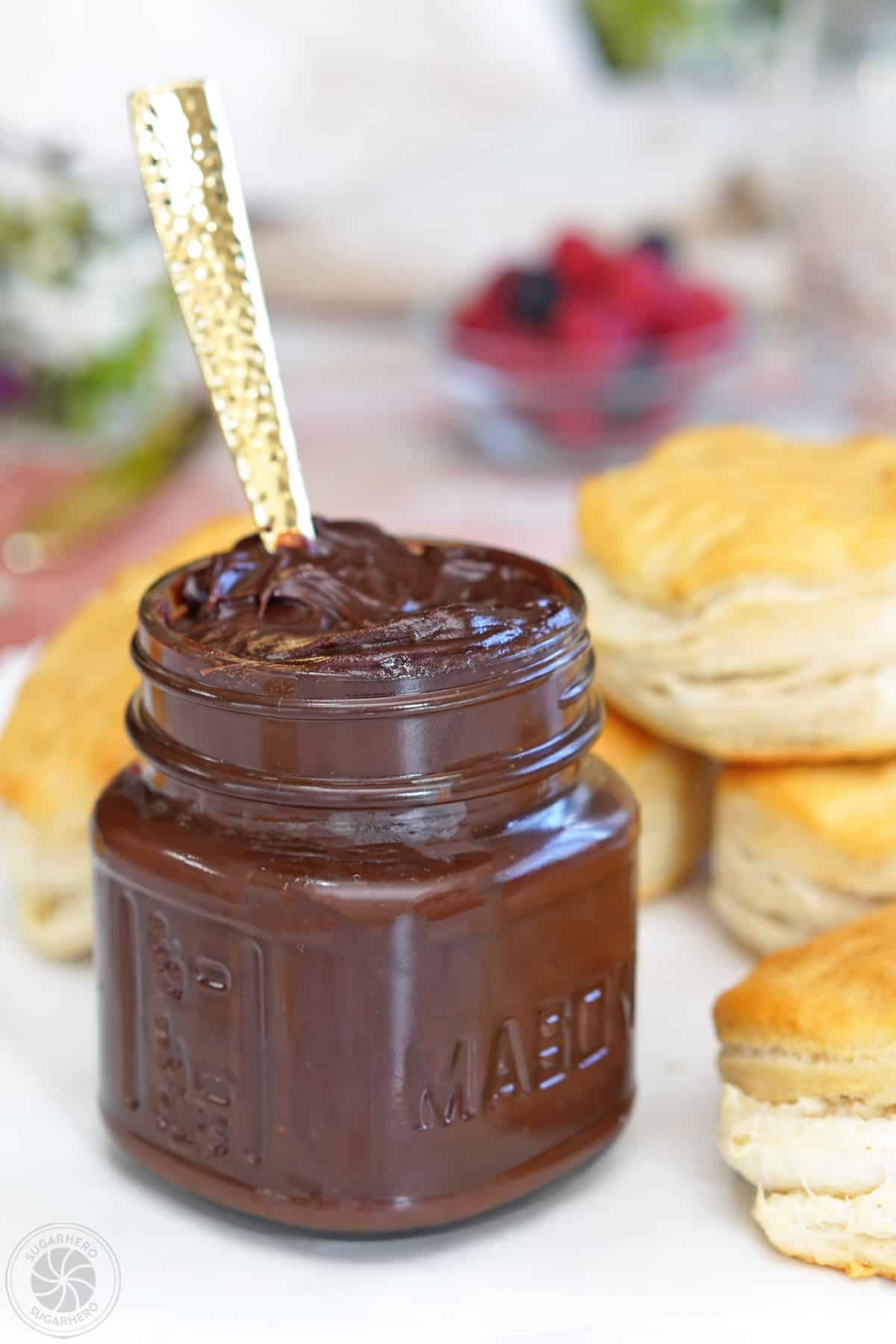 A small jar of Sugar-Free Chocolate Spread with a gold spoon in it.