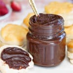 A small jar of Sugar-Free Chocolate Spread with a covered biscuit.