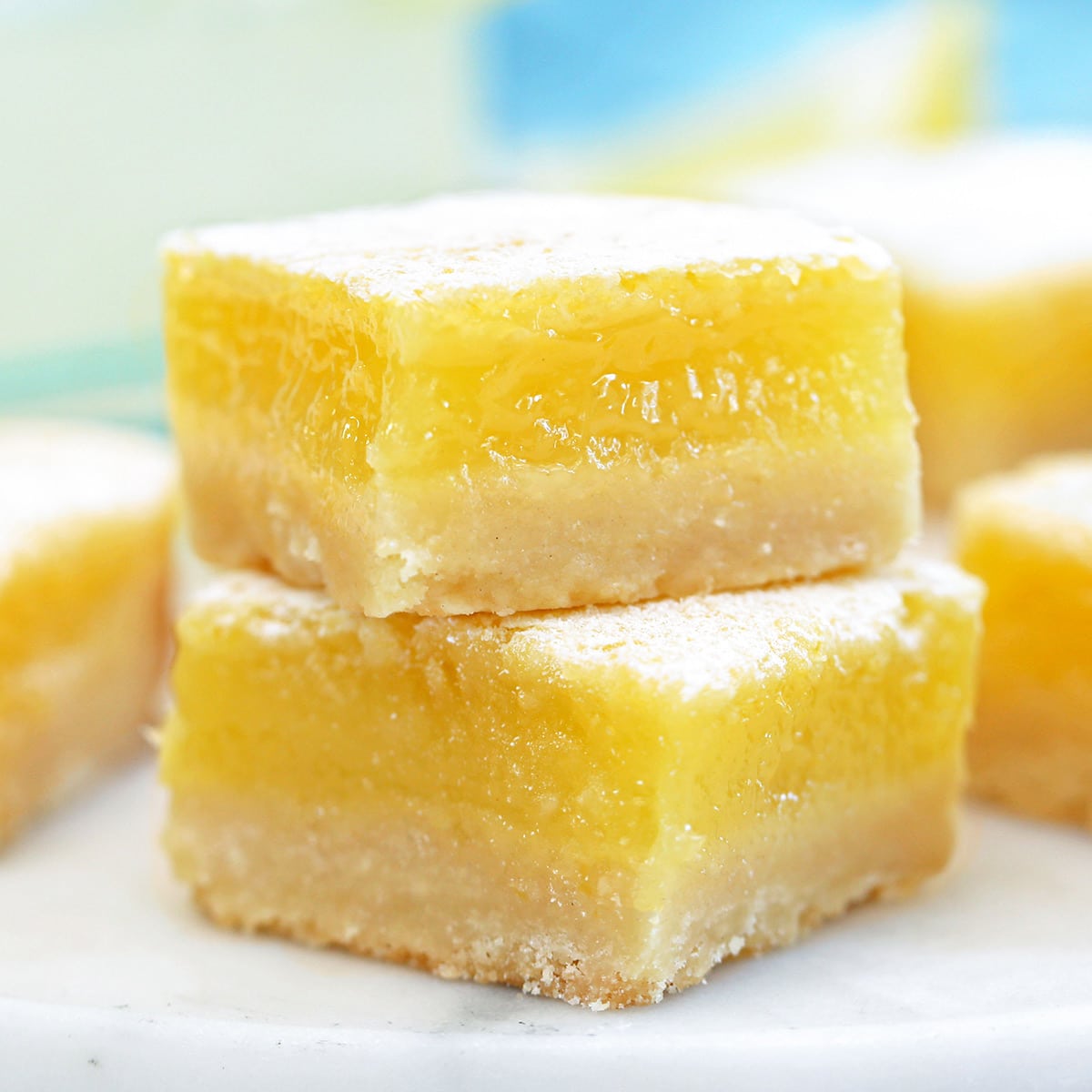 Close up of two square lemon bars.