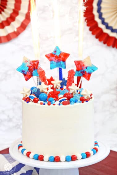 Close up of a Fourth of July Layer Cake with sparklers on top.