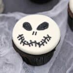 Close up of a Skull Cupcake on white material.