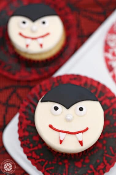 Close up of a Vampire Cupcake with a red and block wrapper.