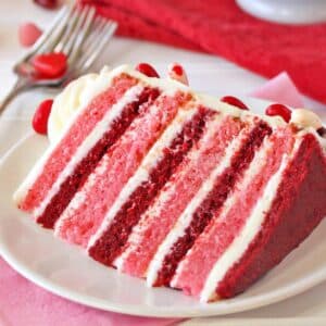 Slice of Pink and Red Velvet Cake on a white plate.