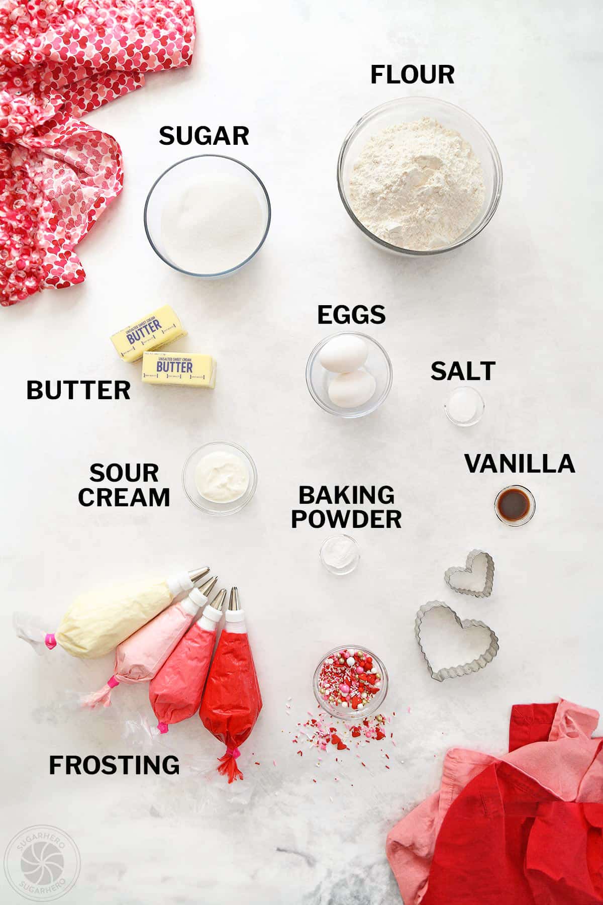 Overhead shot of ingredients needed to make sugar cookies with piped buttercream.
