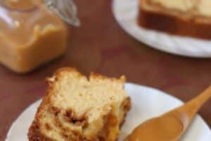 A broken slice of Dulce de Leche Swirl Pound Cake next to a spoonful of dulce de leche.