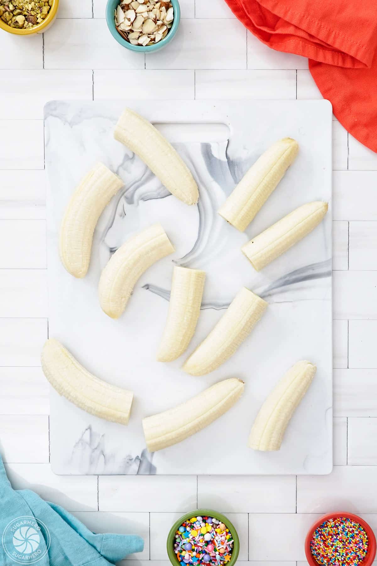 Bananas cut in half on a cutting board.