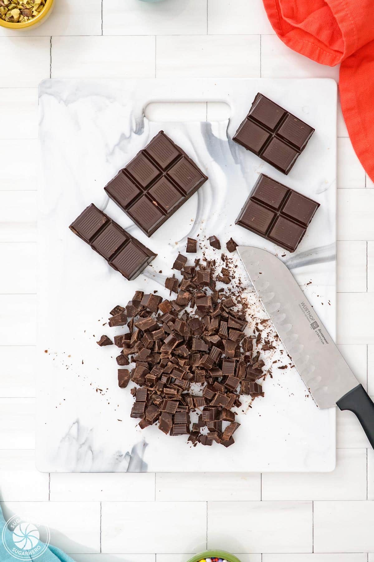 Chopped chocolate on a cutting board.