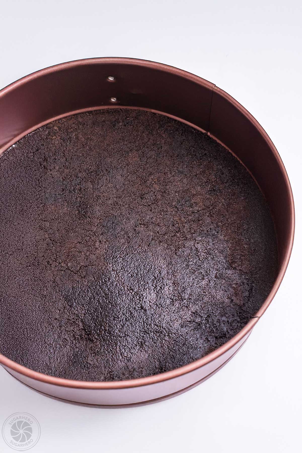 Oreo cookie crust pressed into a springform pan.