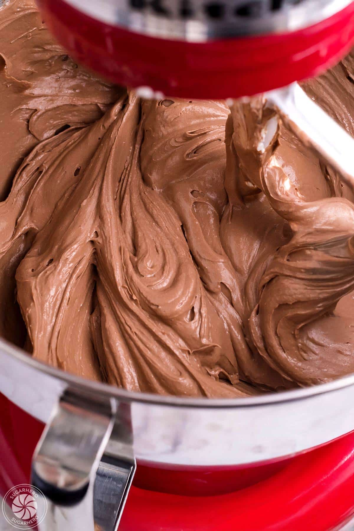 Chocolate cheesecake batter in a red mixer.