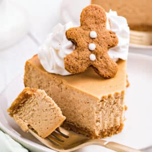 A slice of Gingerbread Cheesecake with a bite removed on a fork.