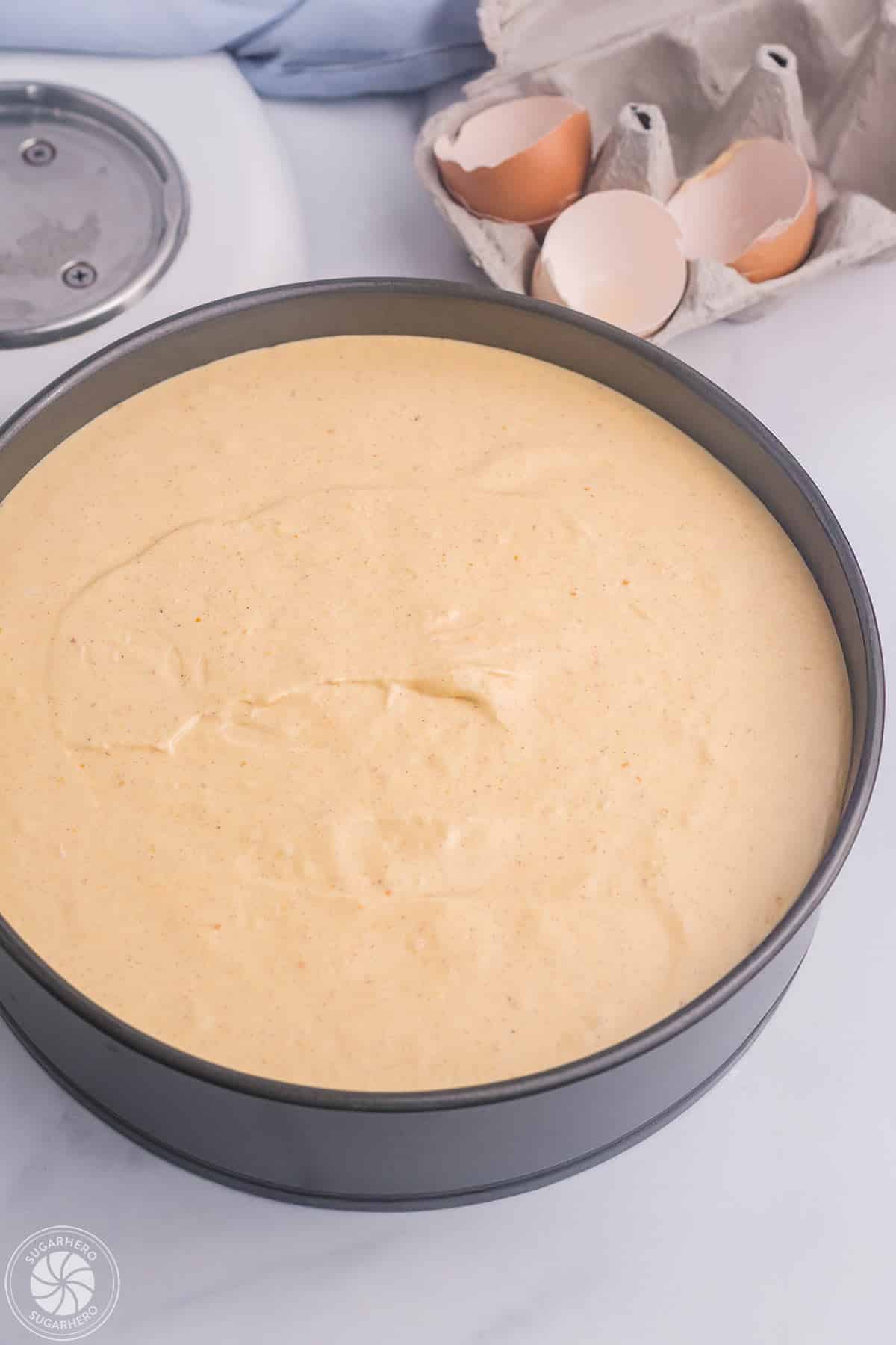 A springform pan filled with pumpkin spice cheesecake filling.
