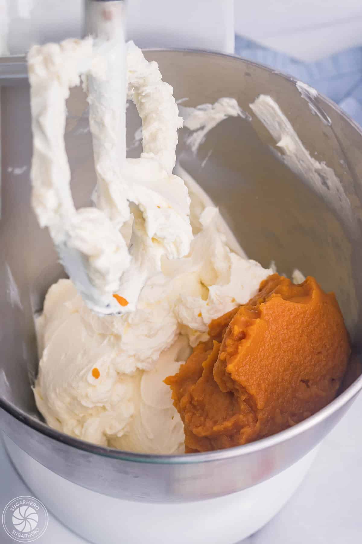 Adding pumpkin puree to whipped cream cheese.