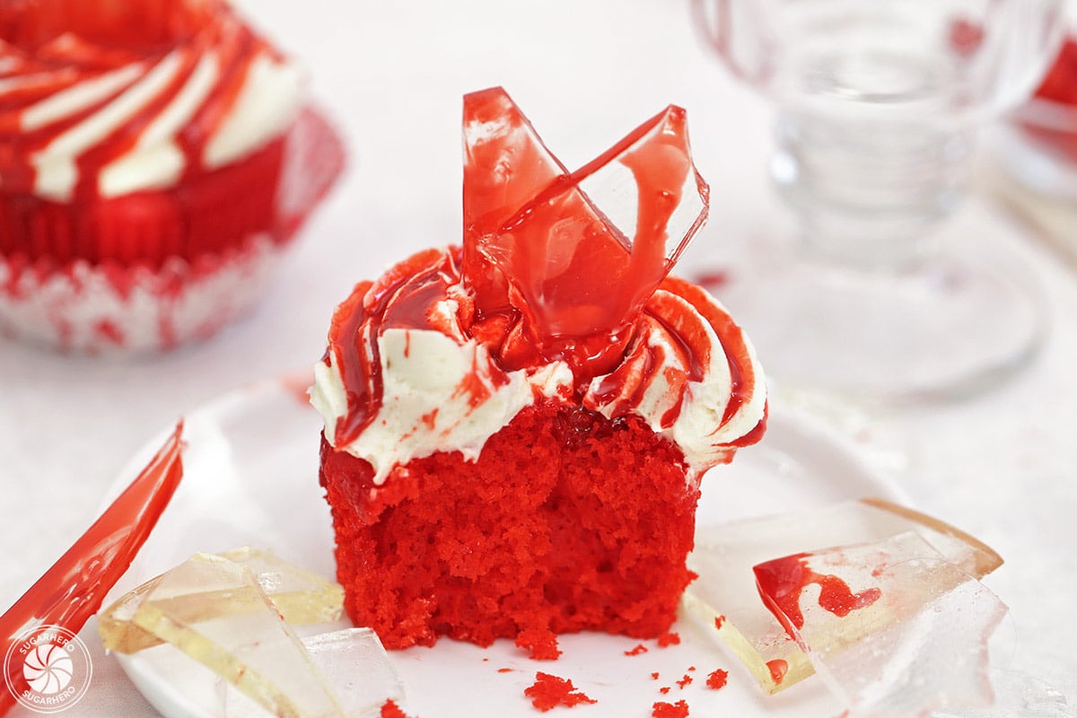 Close up of a bloody glass cupcake with a large bite removed.