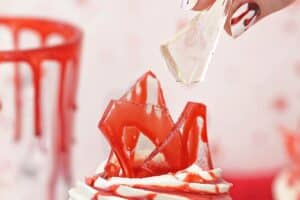 An image of bloody glass cupcakes with text overlay for Pinterest.
