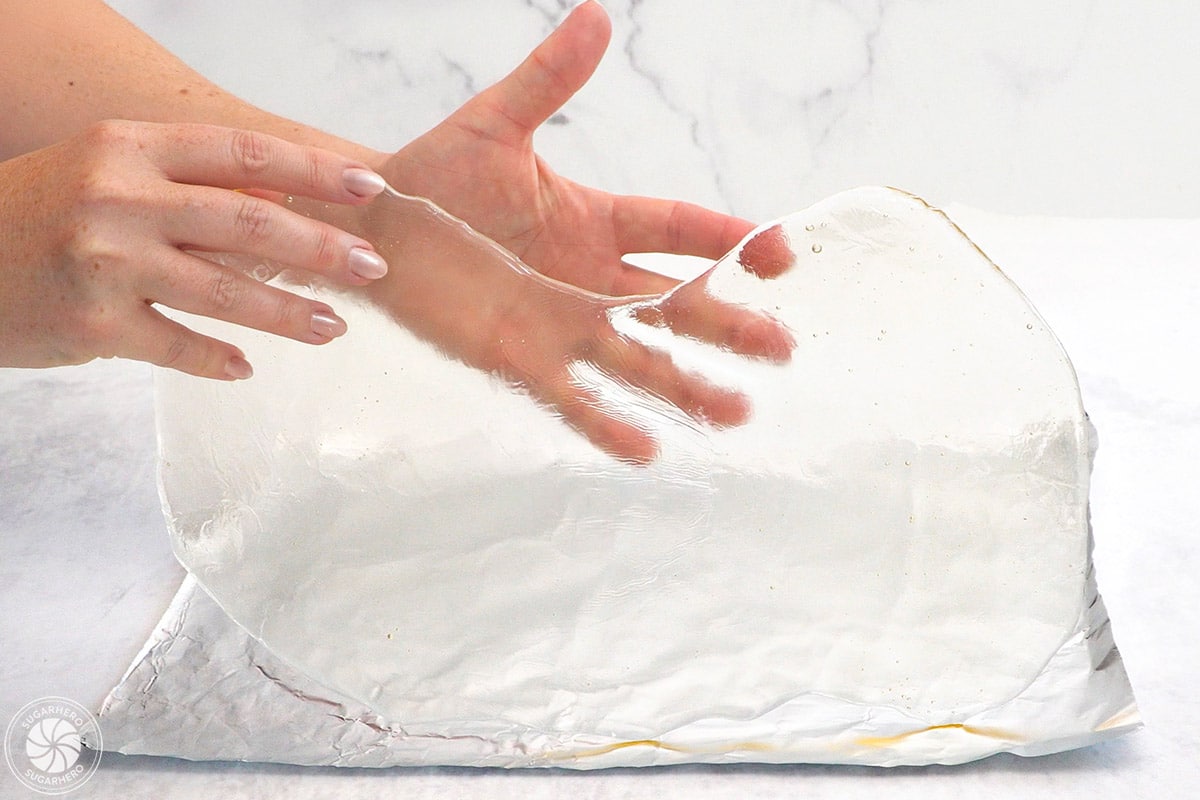 Hand showing a large piece of sugar glass.