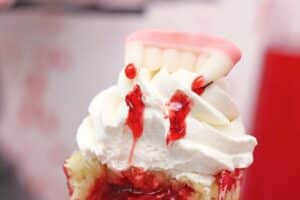 An image of a vampire bite cupcake with text overlay for Pinterest.