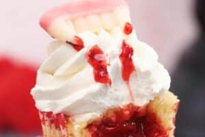 An image of a vampire bite cupcake with text overlay for Pinterest.