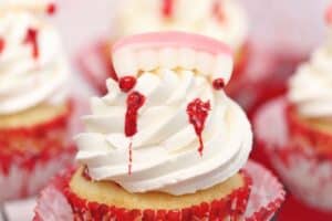 An image of a vampire bite cupcake with text overlay for Pinterest.