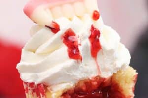 An image of a vampire bite cupcake with text overlay for Pinterest.