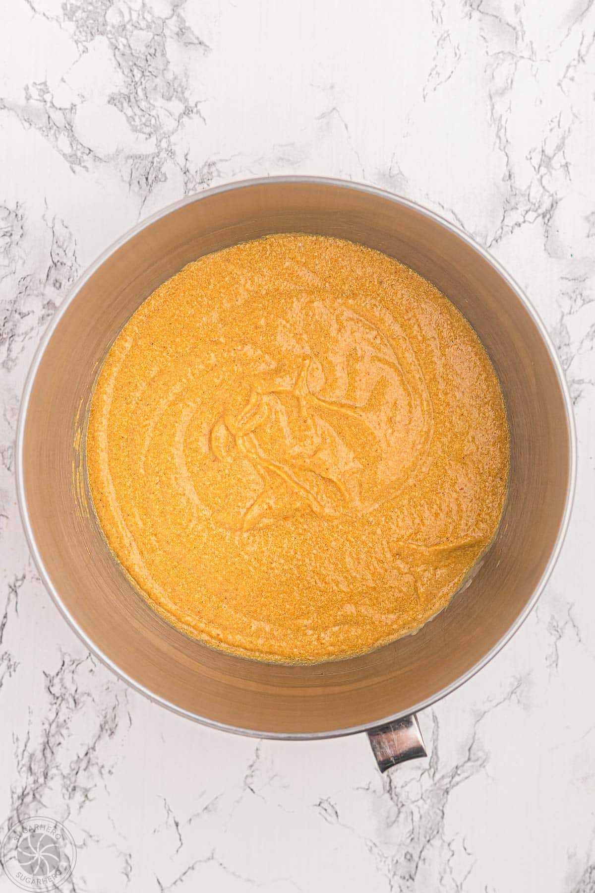 Fully mixed pumpkin spice cupcake batter in a mixing bowl.