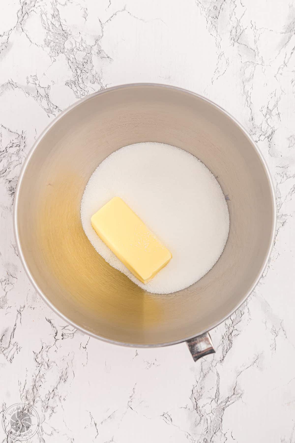 Butter and granulated sugar in a mixing bowl.
