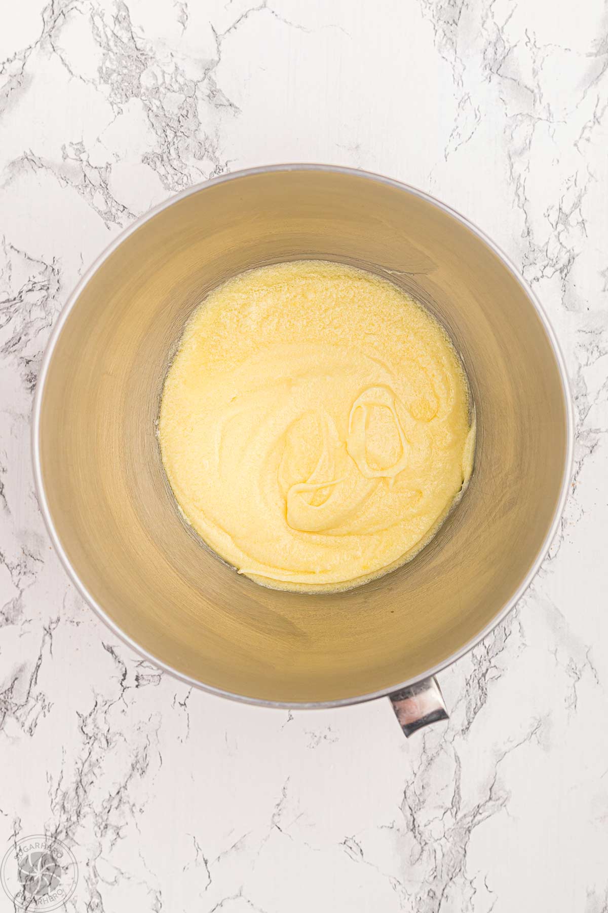 Cupcake batter in a mixing bowl once eggs have been mixed in.