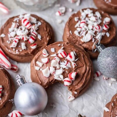 Three chocolate peppermint lofthouse cookies witha bite taken out of the first cookie.
