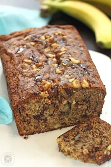 A loaf of banana bread with a piece cut off.