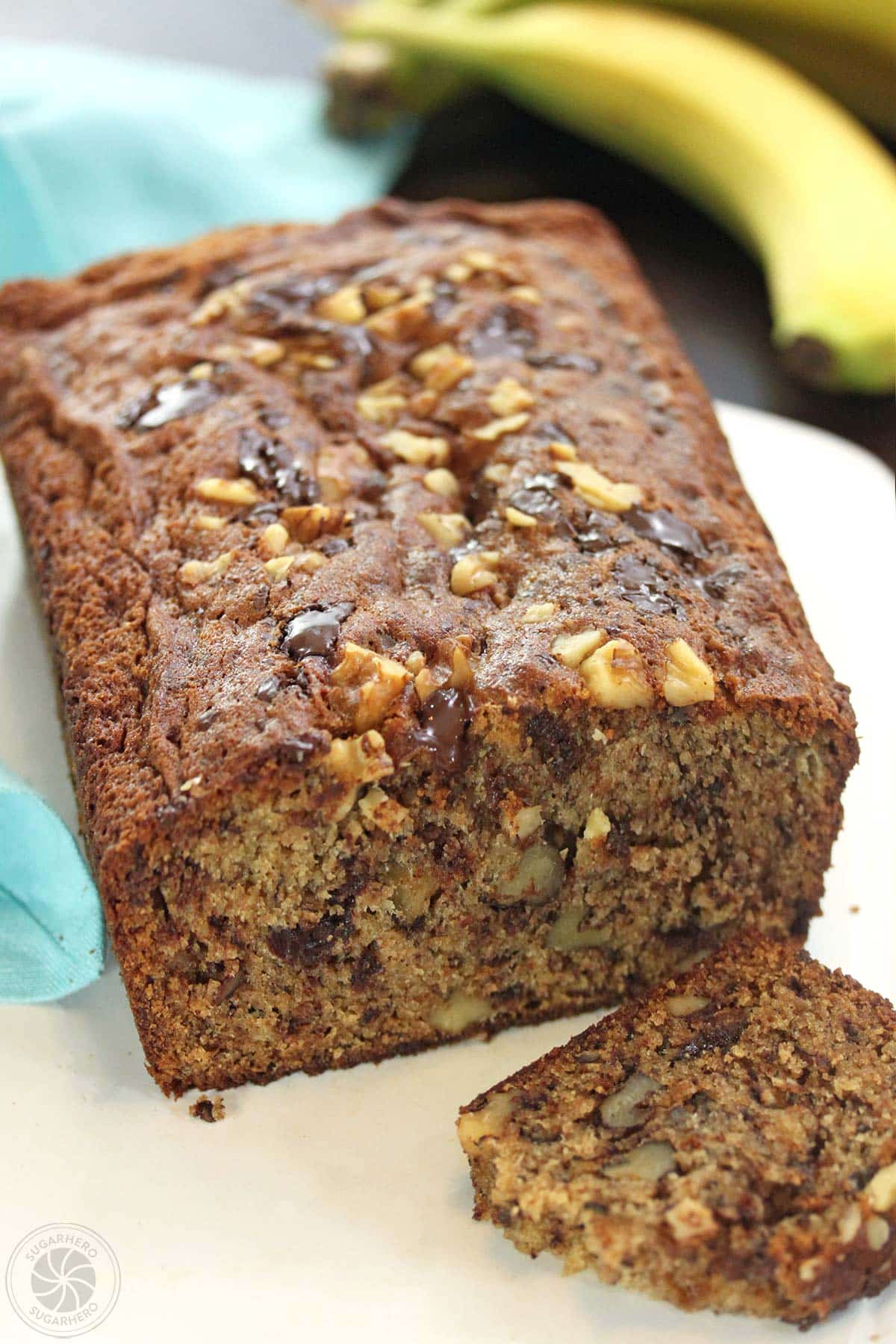 A loaf of banana bread with a piece cut off.