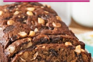 An image of banana coconut macadamia nut bread with text overlay for pinterest.