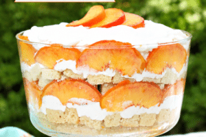 An image of peaches and cream trifle with text overlay for pinterest.